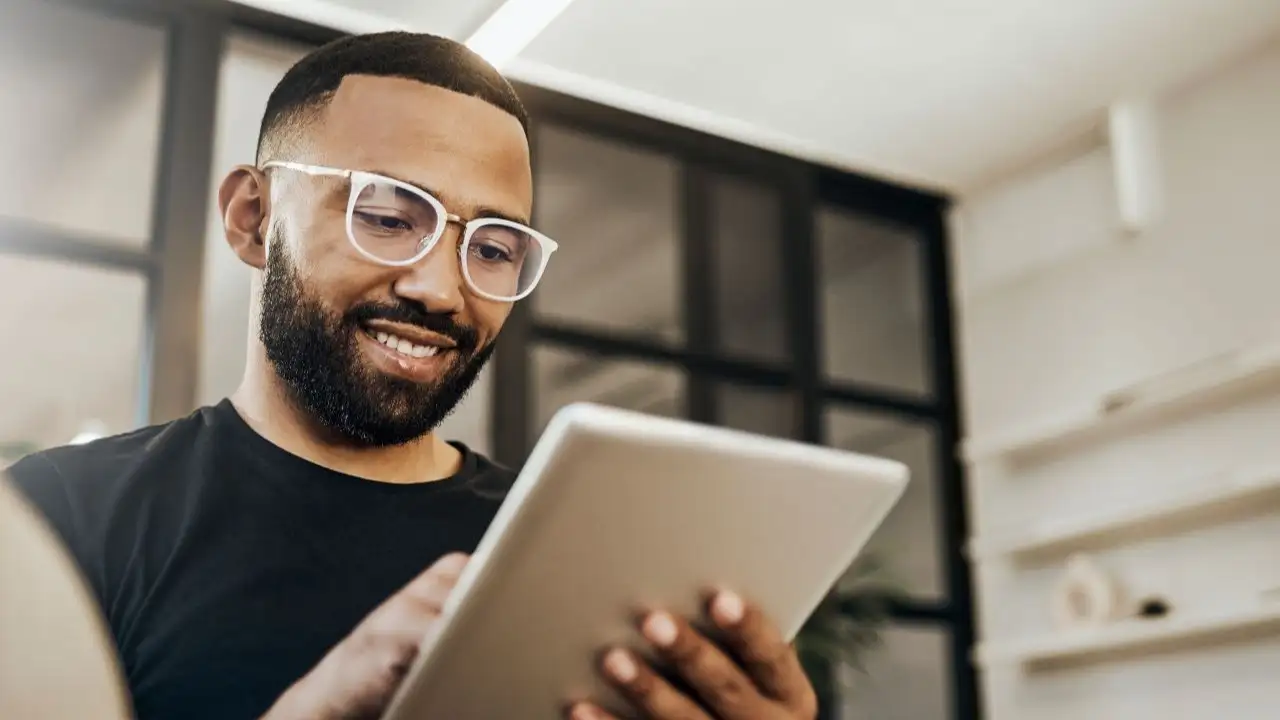 Man checking his credit score on tablet