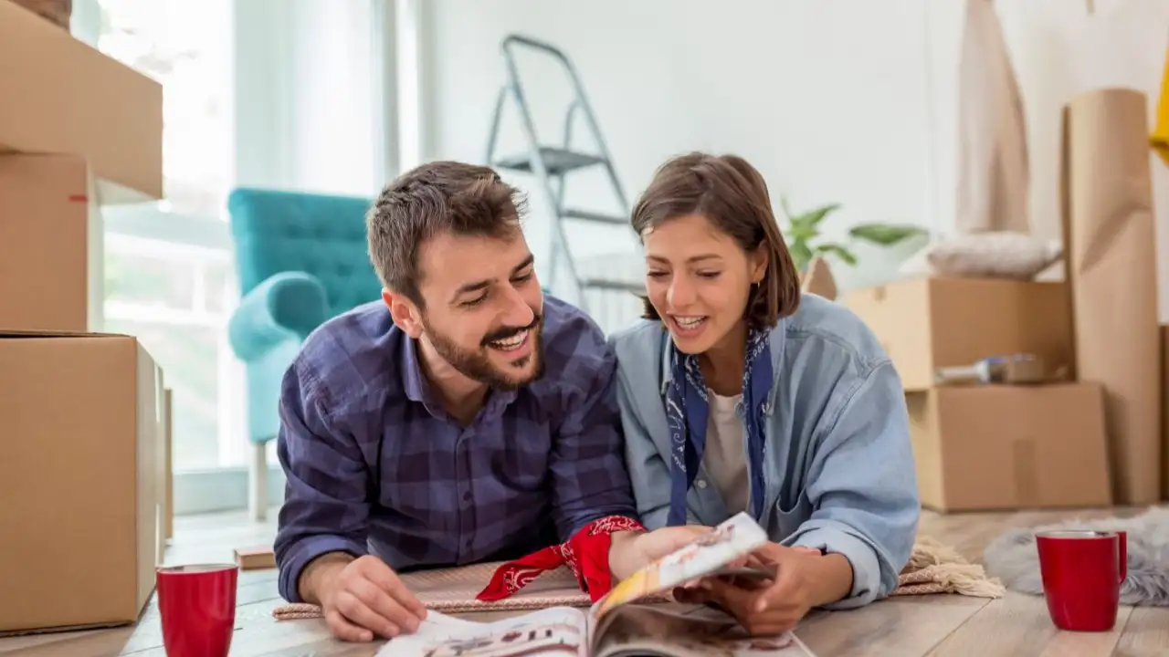 Couple lying on the floor of their home in the midst of home renovations