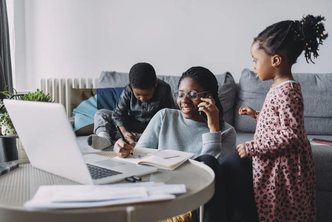 Super Mom: A Young Businesswoman and Her Boy and a Girl Spending Creative Time Together at Home