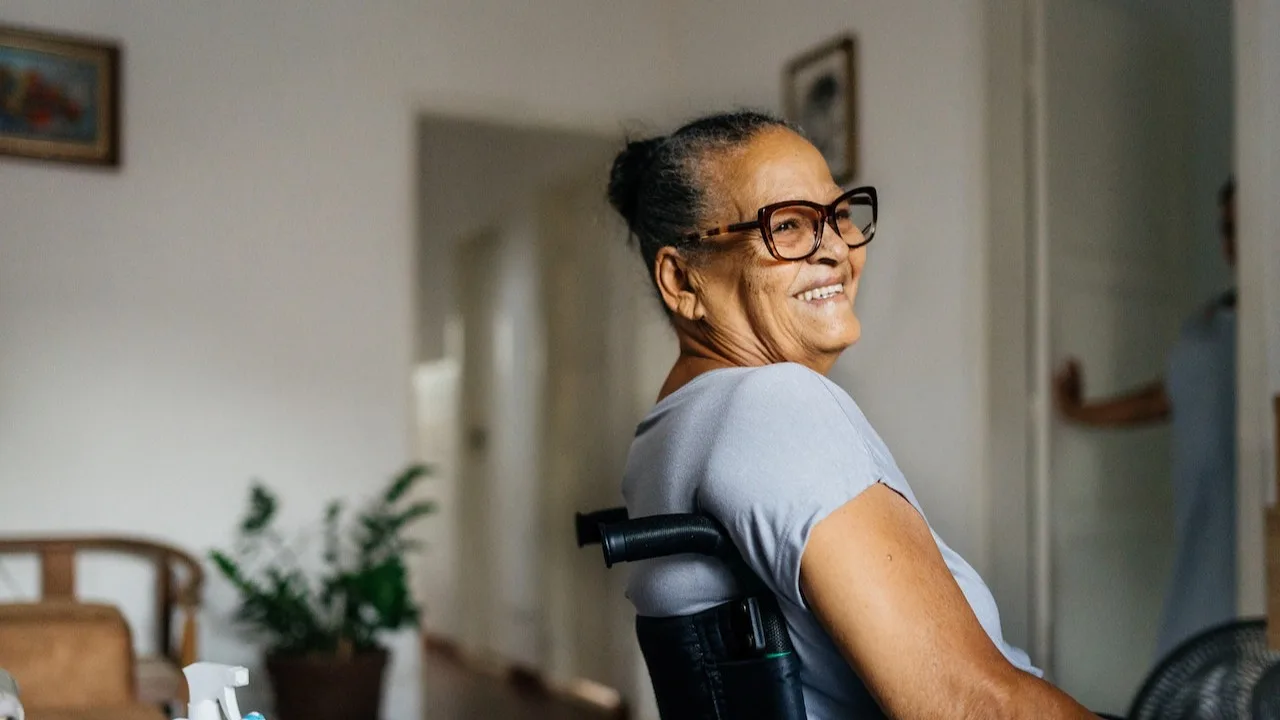 Happy elderly woman in the wheelchair