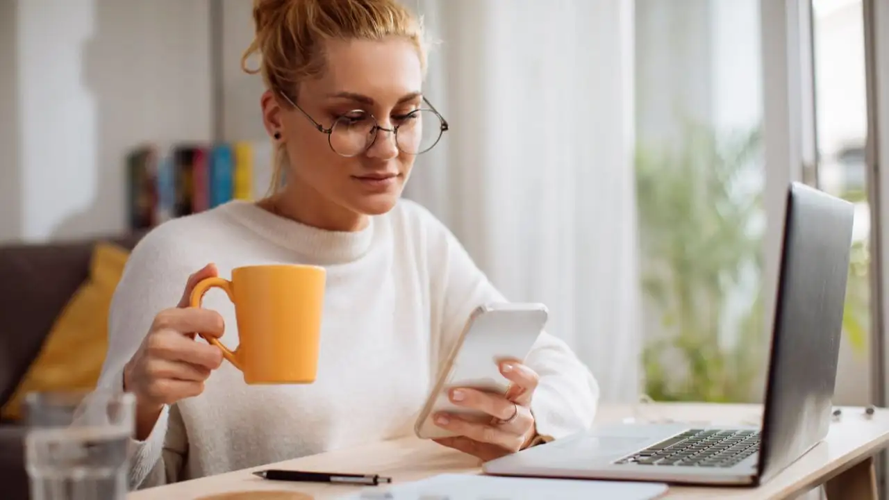 Young women drinking coffee and reviewing her finances