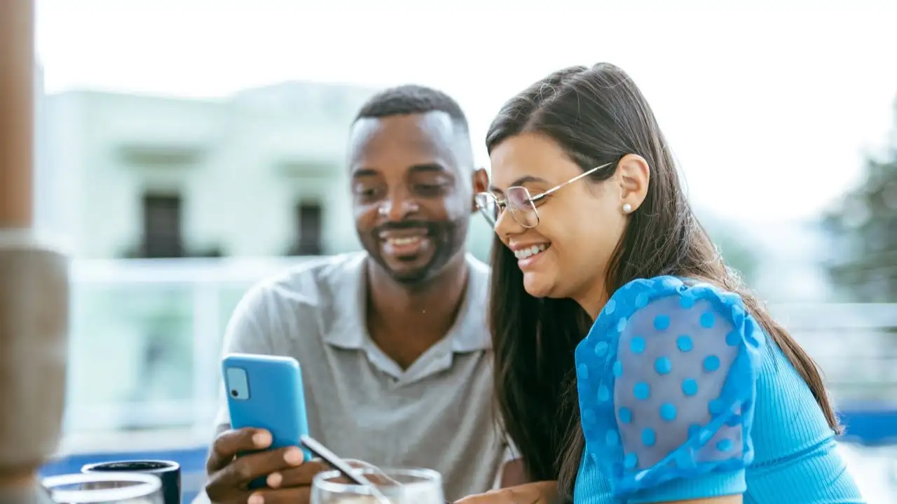 Couple eating breakfast out and acknowledging financial freedom