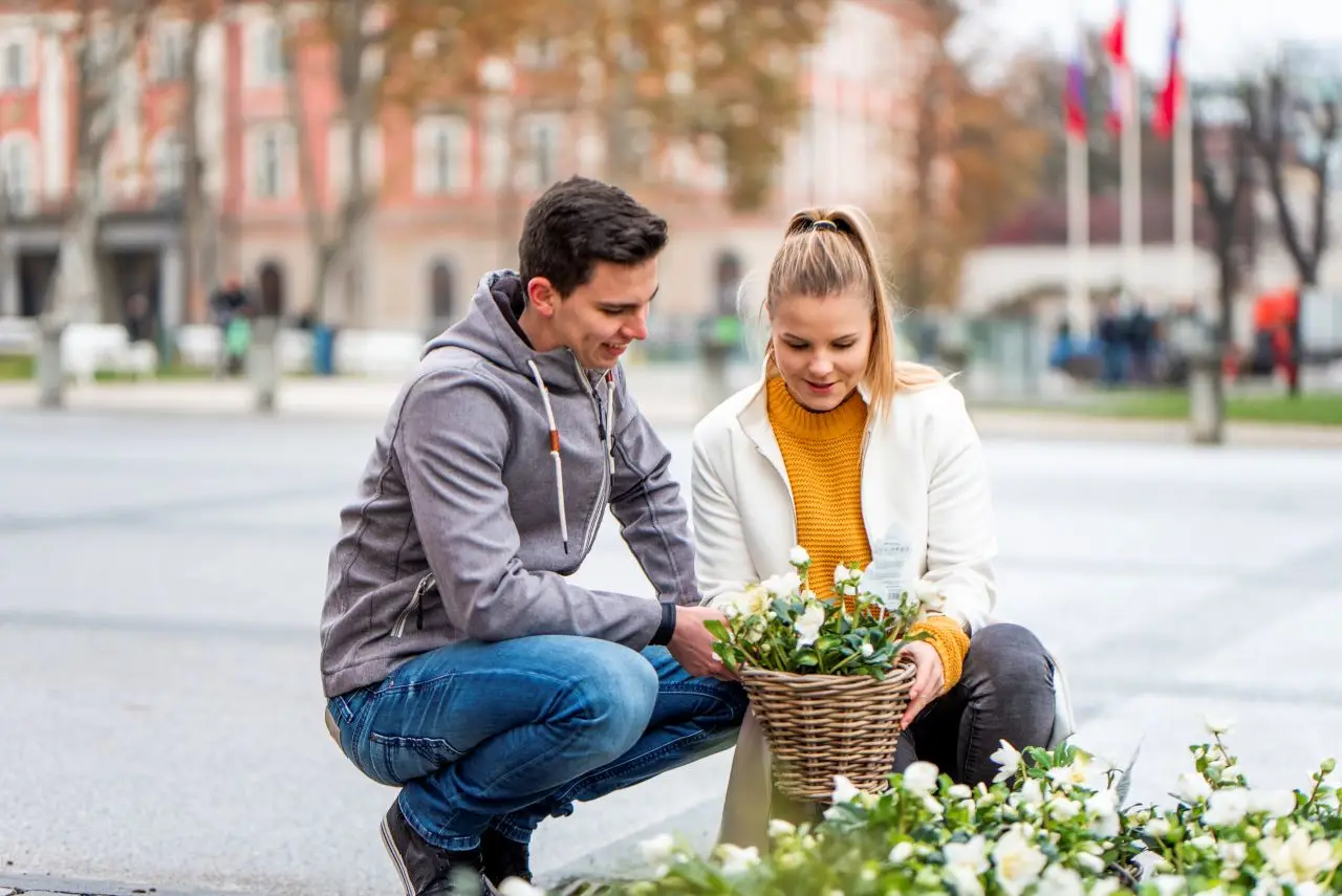 Young couple admiring flowers in the city.