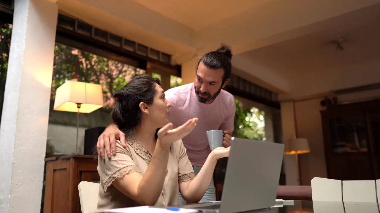 Worried couple having problems with their financial bills at home.