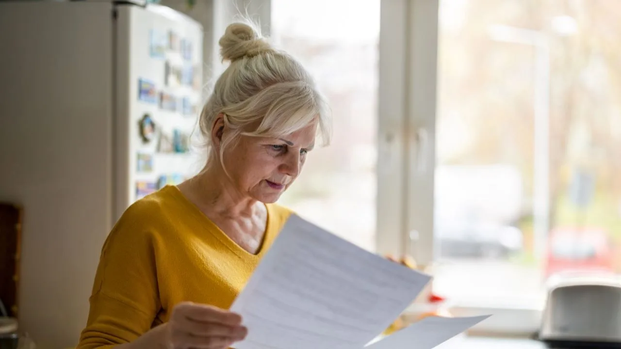 Senior woman checking bills