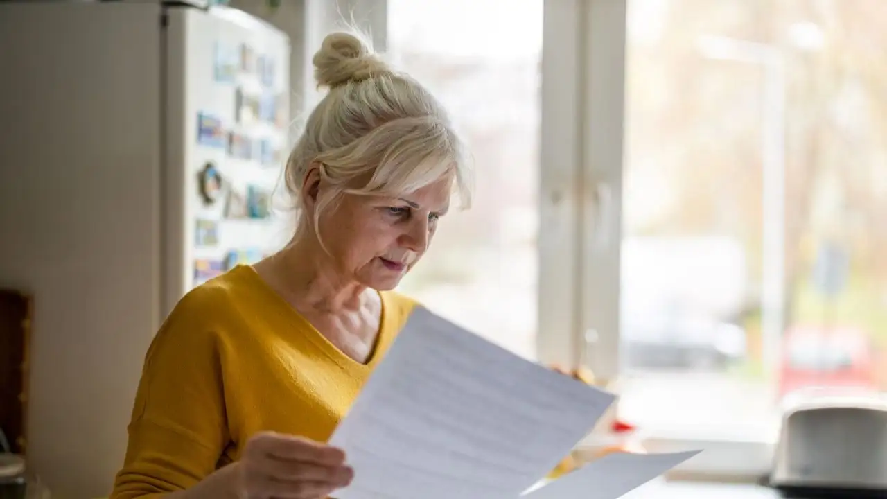 Senior woman checking bills