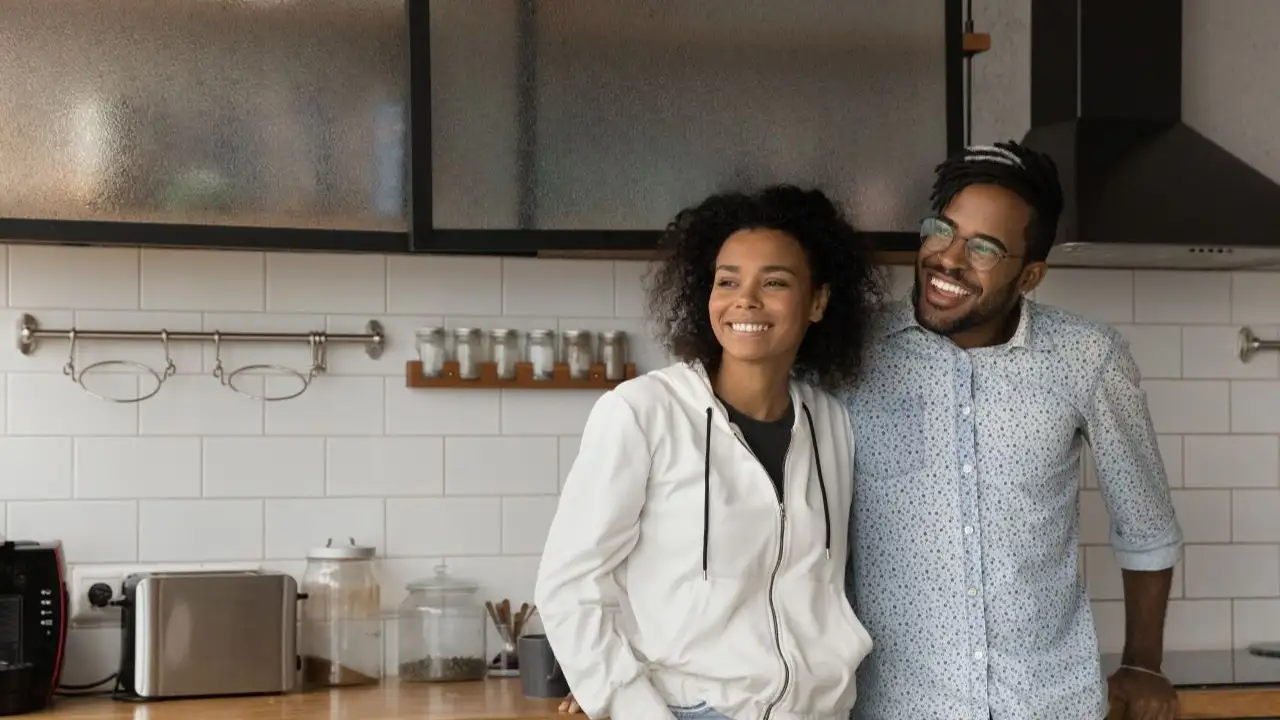 Young couple renters pose in own modern home look in distance dreaming planning