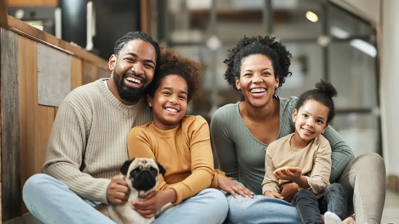 Happy family and their dog enjoying at home. 