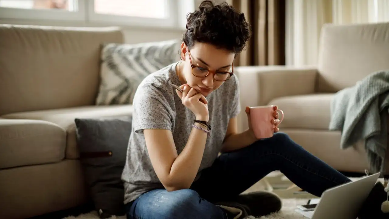 Young woman at home reviewing finances