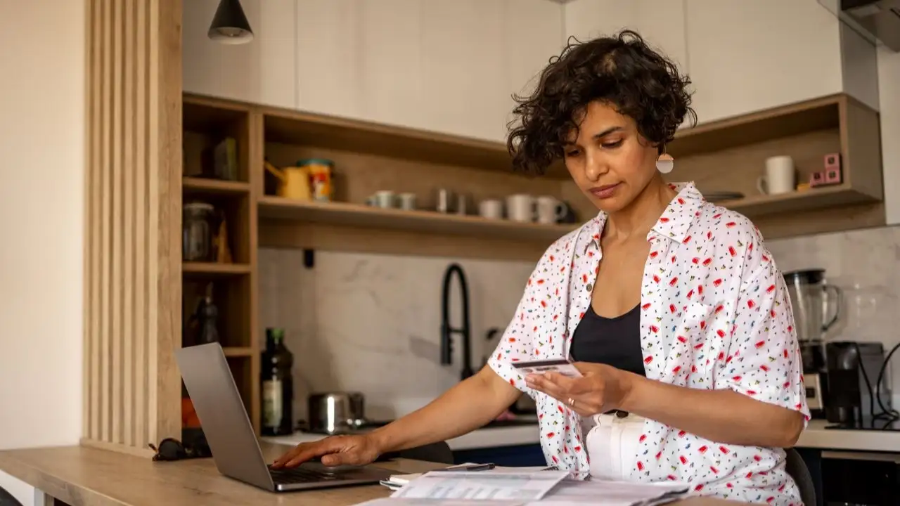 Woman paying her house bills with credit card online