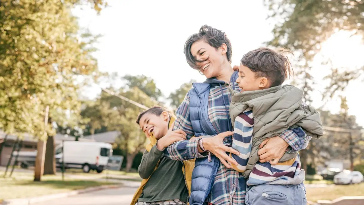 Mother and two children playing outside