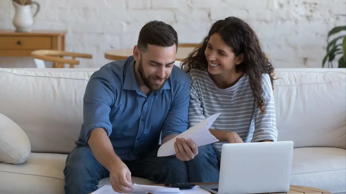 Happy couple homeowners preparing HELOC application