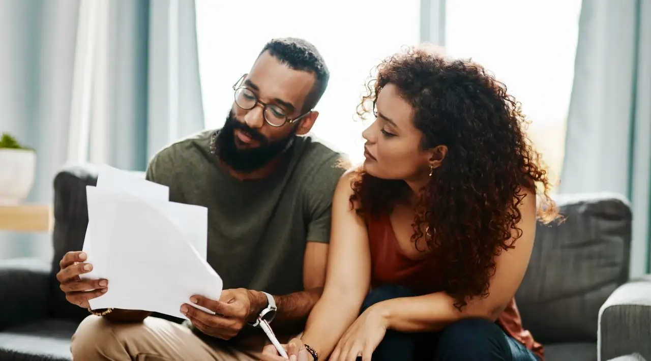 Shot of a young couple going over their finances together at home