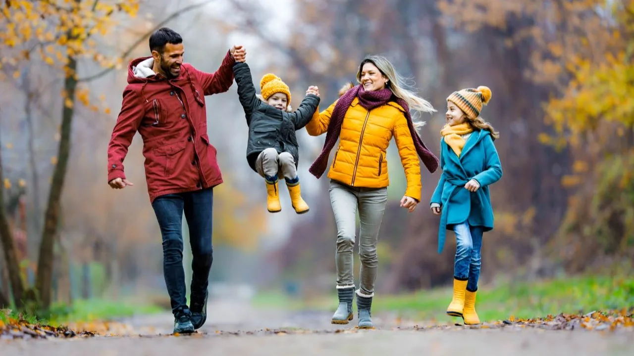 Enjoying financial security. Carefree family having fun in winter day at the park
