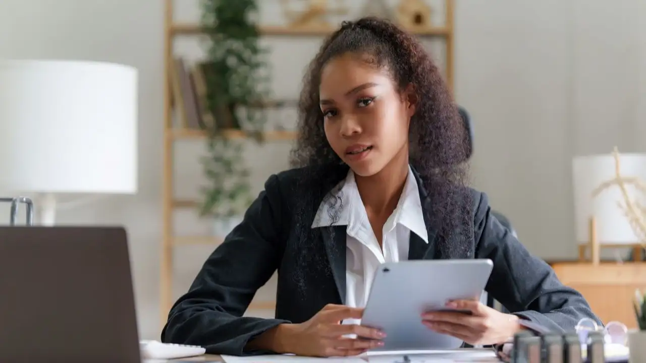 Woman  with calculator and paperwork  before applying for a personal loan