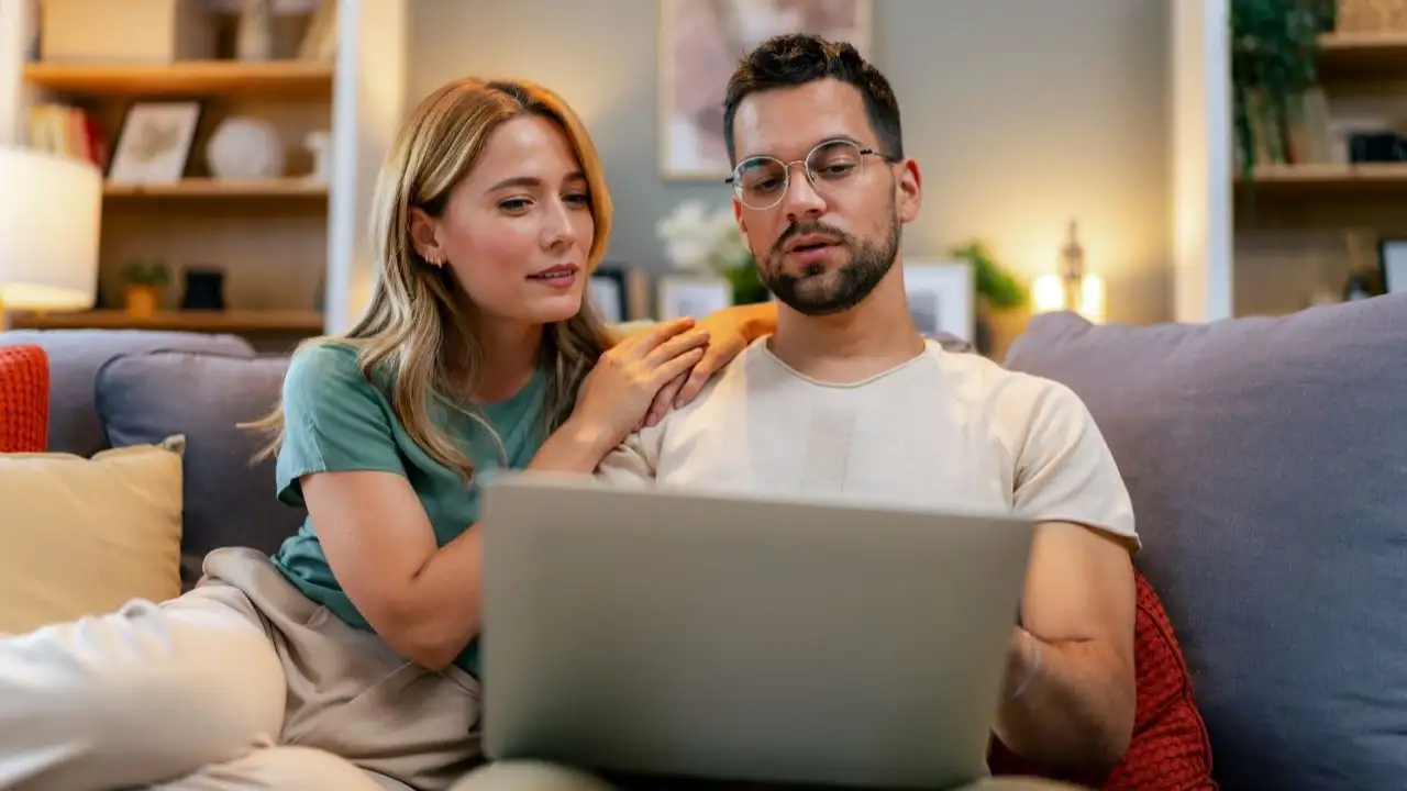 Young couple reviewing their finances while using their laptop