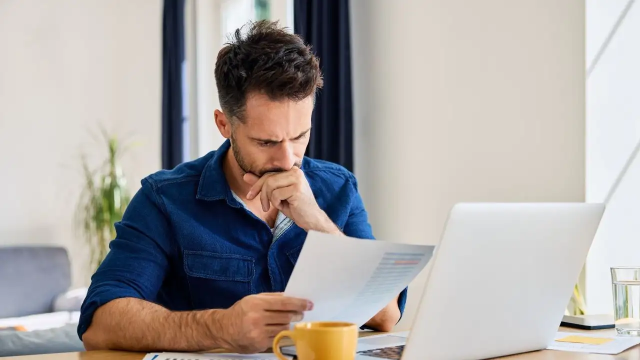 Man looking at finances and worried about wage garnishments