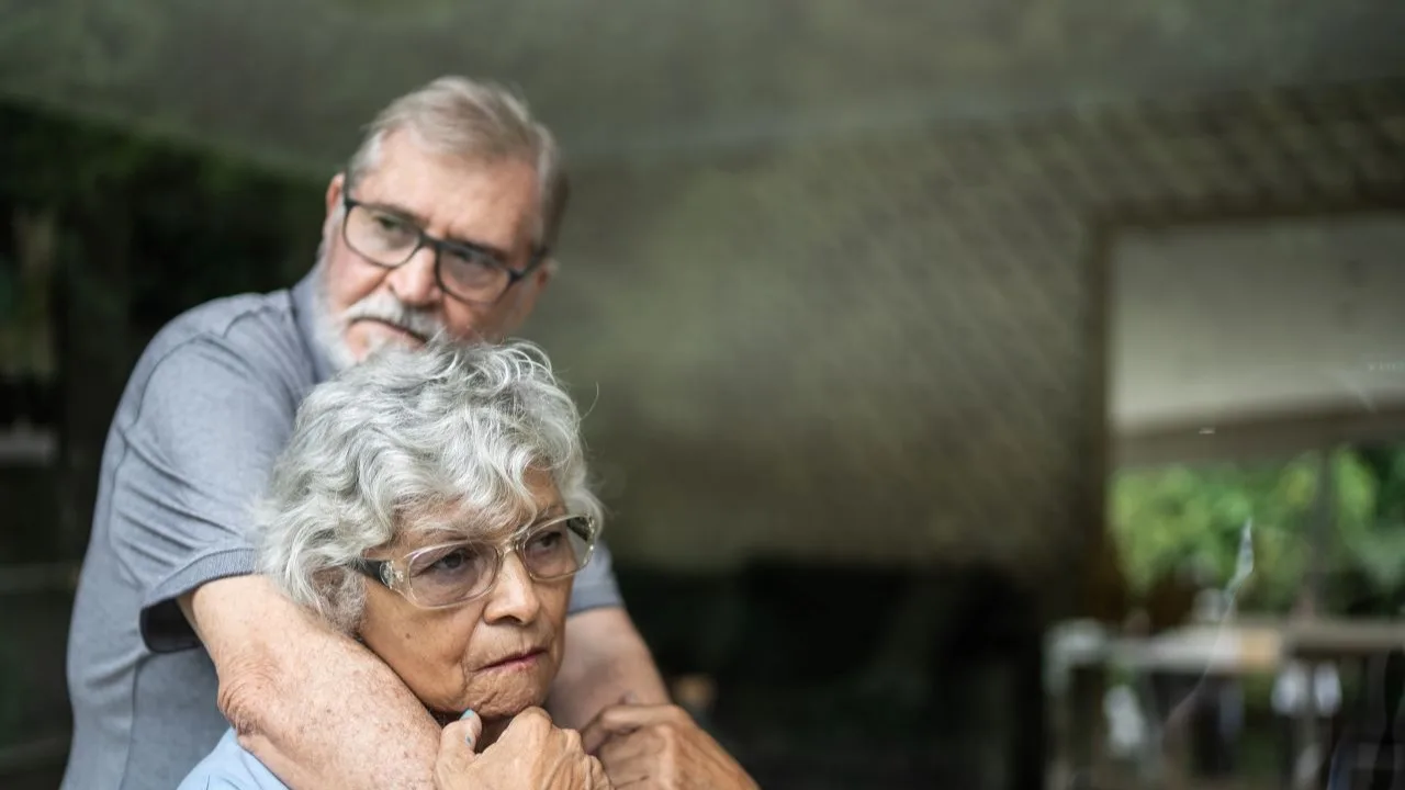 Contemplative senior couple at home
