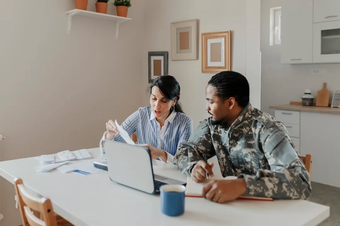 Service member discusses finances with an advisor.
