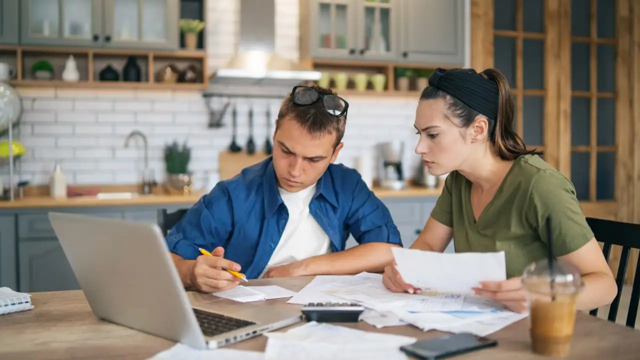 Young couple reviewing finances and credit report