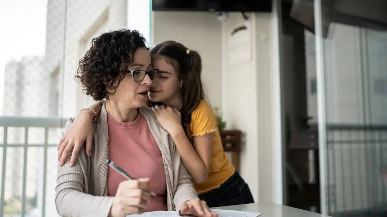 Girl talking to mother while he is working at home