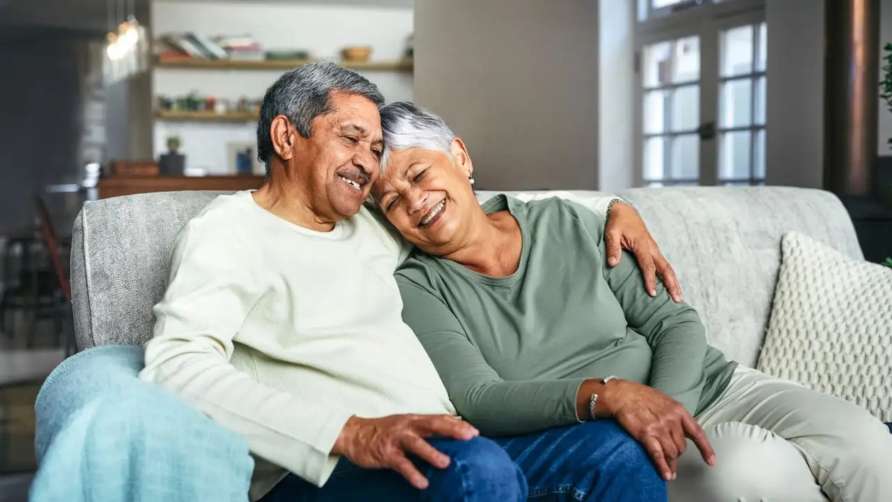 happy senior couple relaxing on the sofa at home