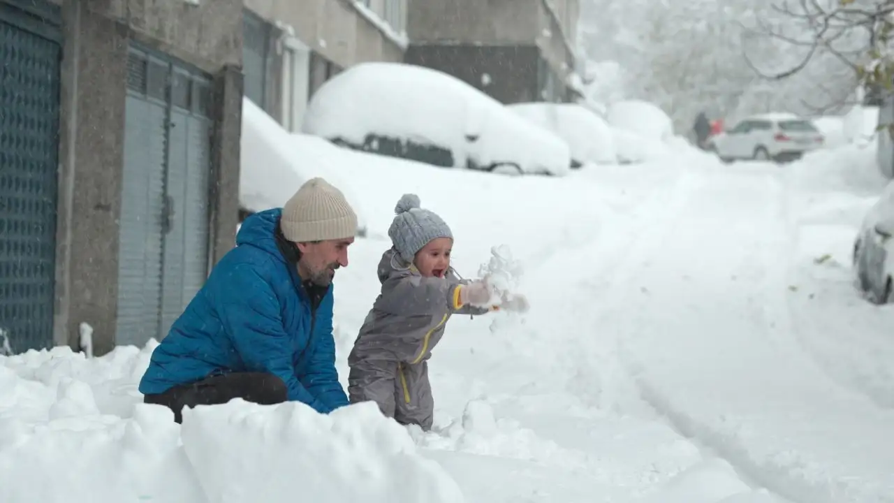 Happy childhood. Family time in winter, playing and laughing in the first snow.