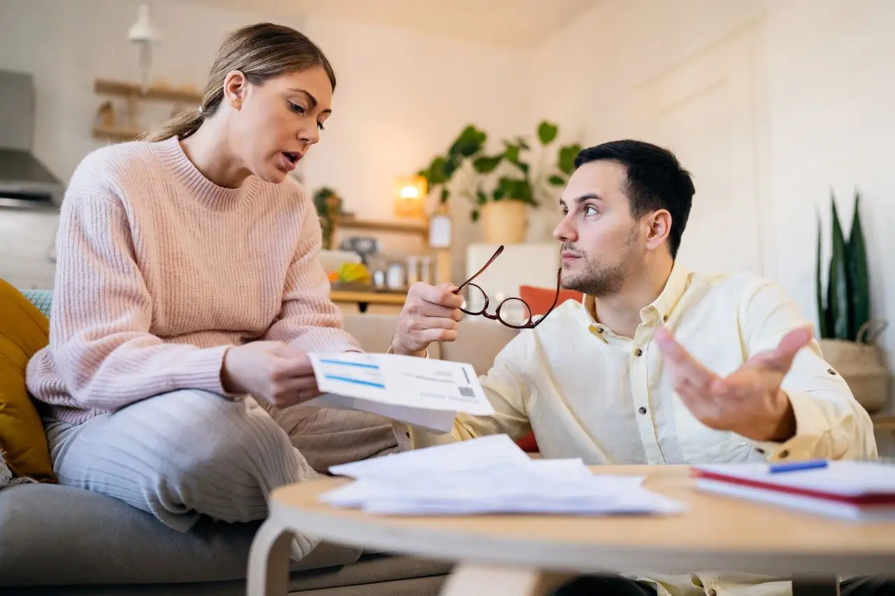 Worried pregnant couple looking at the high electricity bill