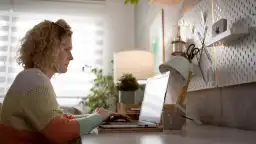 Side-view of woman looking at her laptop